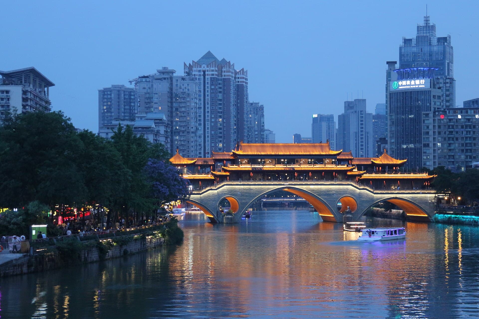 Anshun Bridge glowing over the Jinjiang River at blue hour